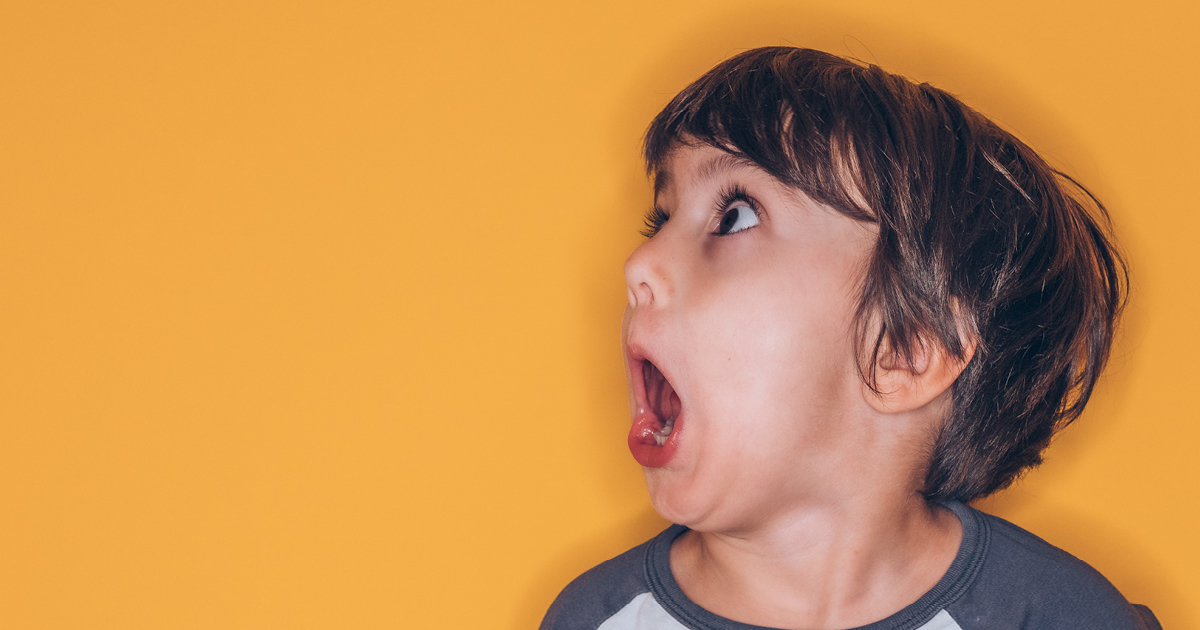 a shocked persons face on a yellow background