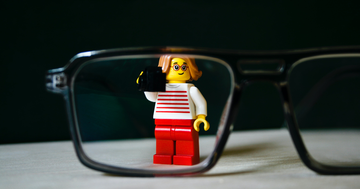 A professional-looking minifigure viewed through business glasses - to show we're searching for the best b2b content examples