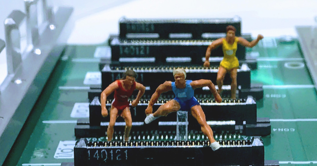 three male dolls jumping over a circuit board