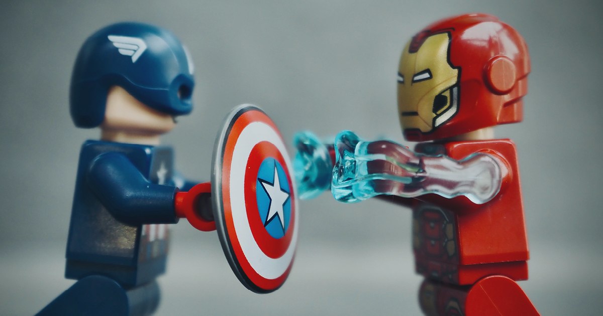two lego heroes figures face to face, one with a shield.