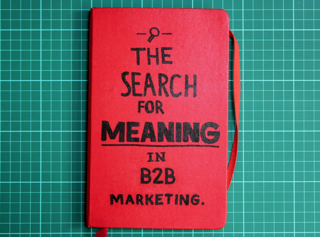 The search for meaning in B2B marketing. Scrawled on the front cover of a red notebook.